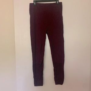 Fabletics like new burgundy leggings with small cutouts on the calf.  Size M